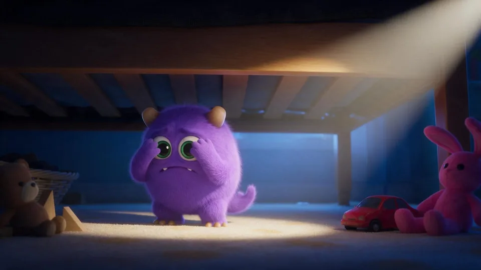 The purple monster hiding under the bed, covering its eyes with its paws, trembling, the bed frame and mattress edge above it.